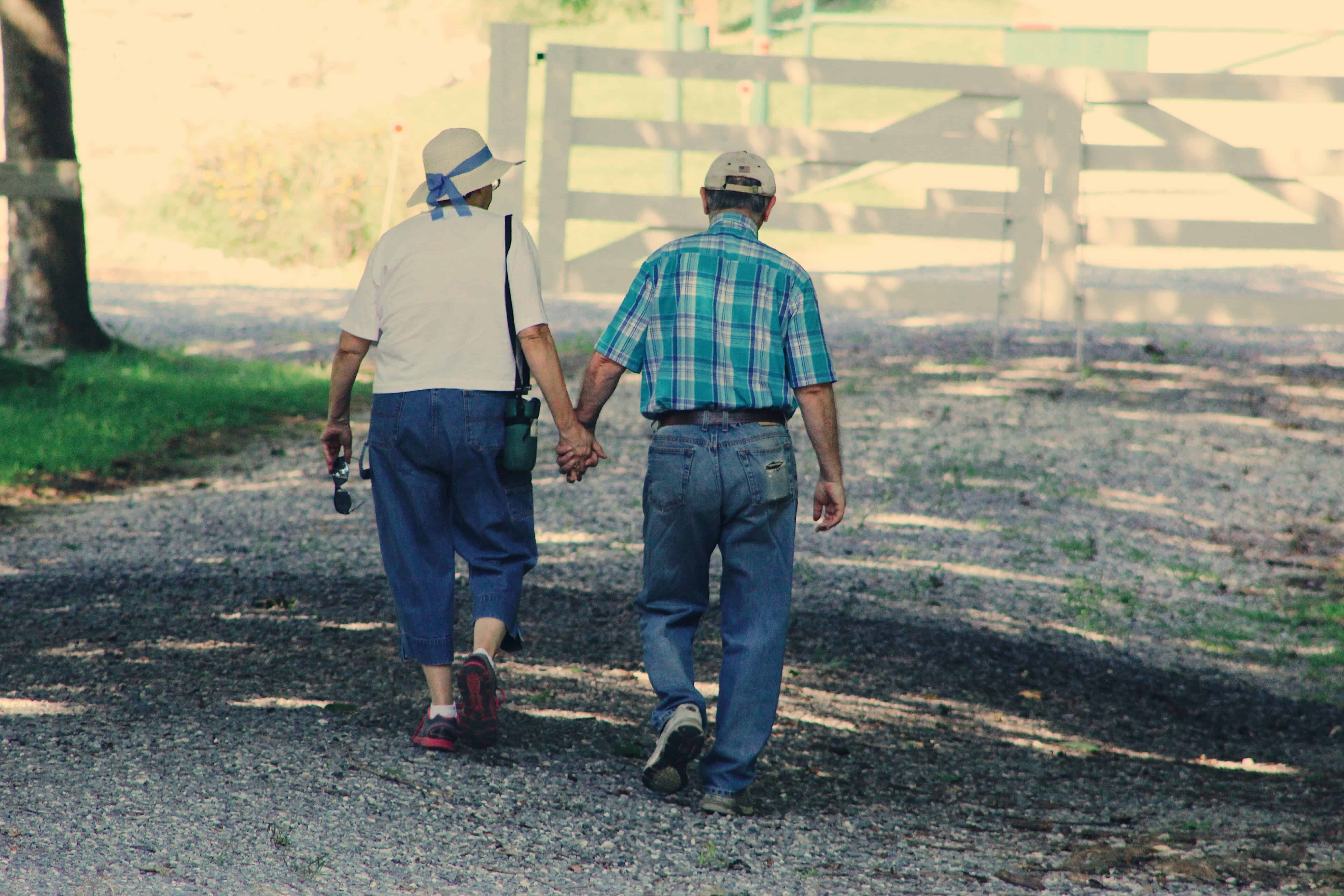 senior-couple-walk-while-holding-hands