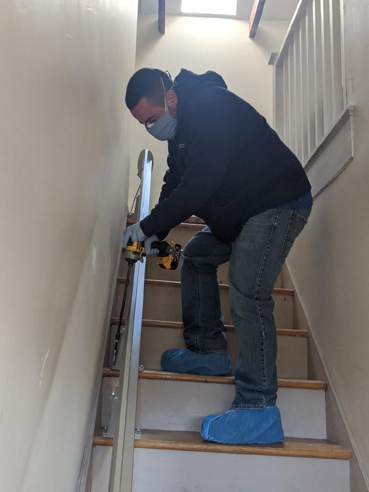 Lifeway-Mobility-technician-installing-a-stairlift-with-protective-grear-duirng-COVID-19