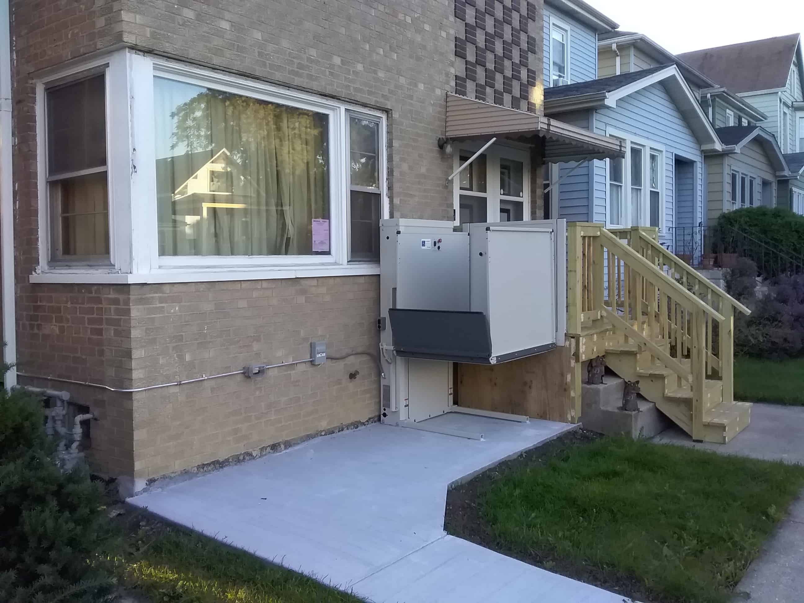 wheelchair lift installed to provide wheelchair access to raised home entrance