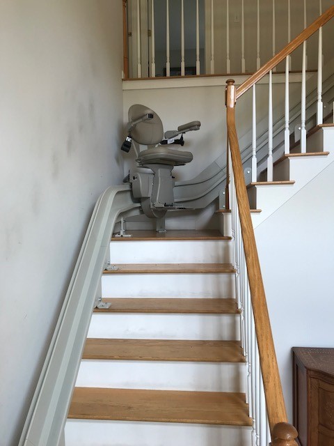 curved stairlift halfway up staircase in home in Massachusetts