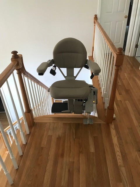 curved stairlift in Massachuetts at top landing with seat swiveled away from the stairs