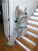 Bruno-curved-rail-stairlift-in-Andover-Massachusetts-with-seat-and-armrests-folded-up.jpg