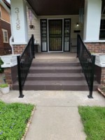 pair of handrails on outdoor staircase for front door access